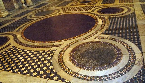 Cosmatesque Quincunx at S. Maria in Cosmedin. The central roundel was often made of porphyry to symbolize Christ's royalty. See Paloma's book Cosmatesque Ornament for more.