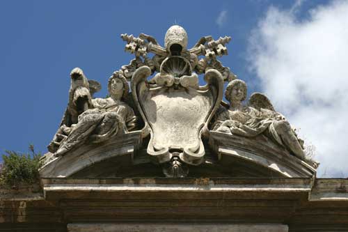 The Papal coat of arms, flanked by angels.