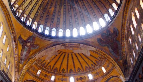 The pendentives of the Hagia Sophia are decorated with Seraphim, the highest of the choirs of angels, with six wings and many eyes (Revelation 4:8). They support the dome of Heaven.
[Image source]