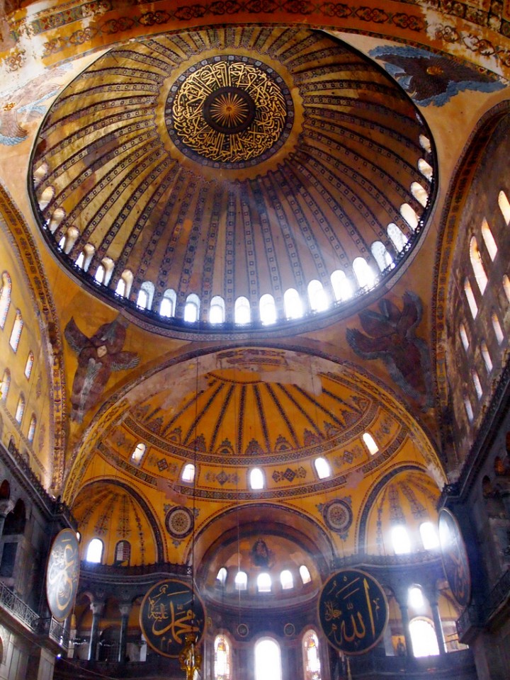 The pendentives of the Hagia Sophia are decorated with Seraphim, the highest of the choirs of angels, with six wings and many eyes (Revelation 4:8). They support the dome of Heaven.
[Image source]