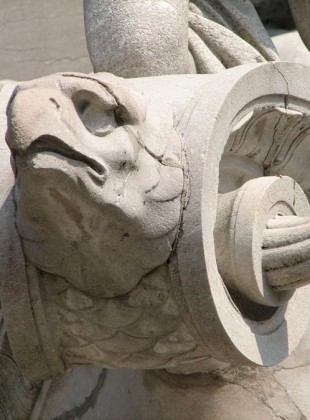 What could be more appropriate than an eagle figurehead? Fish scales cover the volute making the boat more of a chimera than an inanimate object.