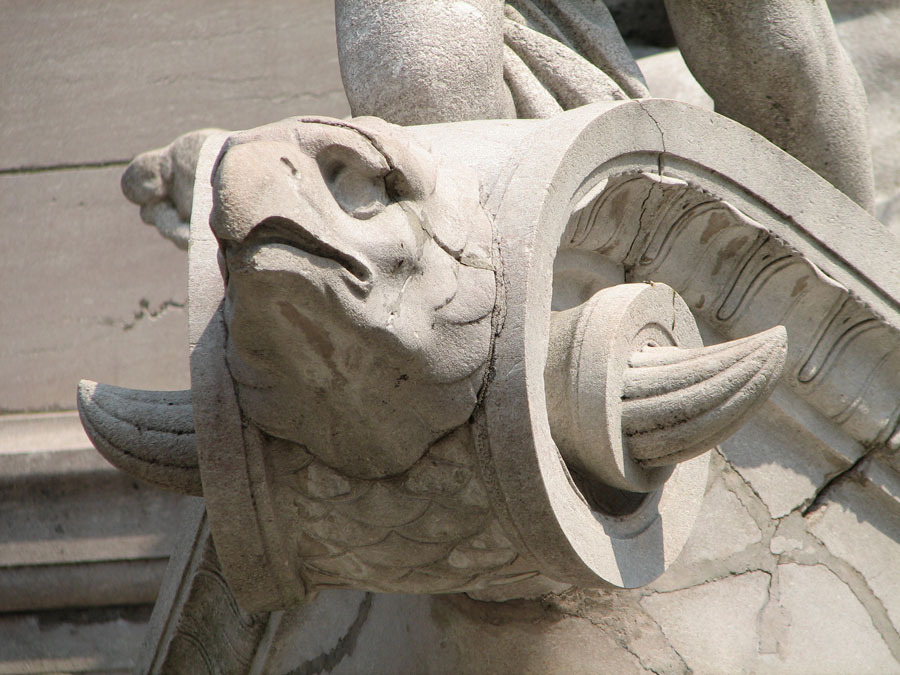 What could be more appropriate than an eagle figurehead? Fish scales cover the volute making the boat more of a chimera than an inanimate object.